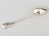 silver spoon on a white surface with a spoon sticking out of it