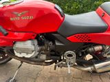a red motorcycle parked on the side of the road