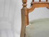 a wooden chair with a green cushion on it