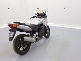 a white motorcycle parked in a room with a white floor