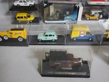 many different types of toy cars in the display case