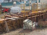 a lot of construction equipment that is outside of a building