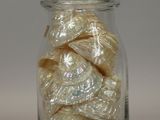 a glass jar filled with white candies on a table