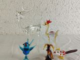 three glass figurines that are sitting on a table