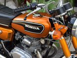an orange motorcycle parked in front of a building
