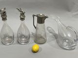 three glass vases and a lemon on a table