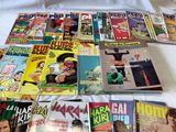 a lot of comic books on a bed with a white comforter