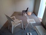 two chairs and a table in a room that is being remodeled
