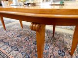 a large wooden table with a glass top on a rug