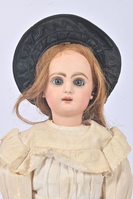 a doll that is wearing a black hat and dress