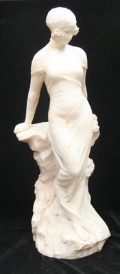 a statue of a woman holding a basket on a black background