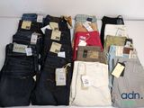 a lot of men ' s jeans on display on a table