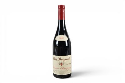 a bottle of red wine sitting on top of a white surface