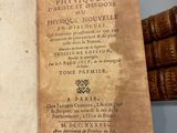 an old book that is open on a table