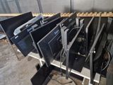 a lot of computer monitors sitting on a shelf