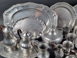 a lot of silver items that are sitting on a table