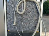 a refrigerator with a hose attached to it on a pallet
