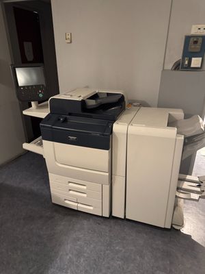 a photo of a printer sitting on a desk in a room