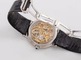 a watch that is on a black leather strap