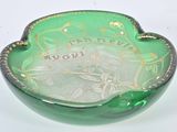 a green glass bowl with a gold decoration on it