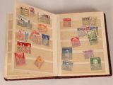 an open book with stamps on it sitting on a table