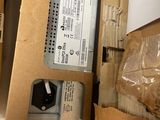 a box of electronic equipment sitting on top of a cardboard box