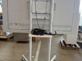 an image of a television on a stand in a warehouse