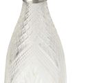 a small glass bottle with a spoon next to it
