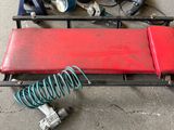 a red bench that has some tools on top of it