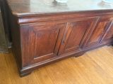 a wooden cabinet with two bowls on top of it