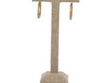 a close up of a pair of earrings on a stand