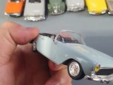 a person holding a toy car in front of a bunch of other toy cars