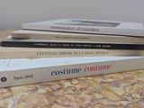 trois livres sont empilés sur une table