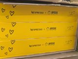 several boxes of coffee are stacked on top of each other in a store