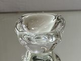 a clear glass candle holder on a glass table