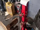 a pile of assorted items on a shelf in a garage