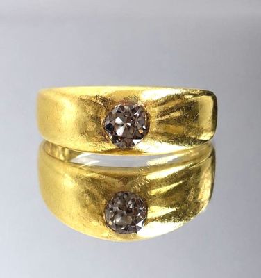 two gold rings with brown diamonds on top of each other
