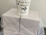 une tasse à café posée sur une pile de cartons