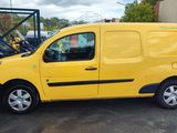the yellow van is parked in the parking lot next to other vehicles