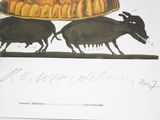 two pigs that are walking in front of a loaf of bread
