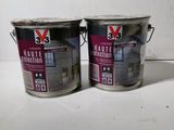 two cans of paint sitting on a table