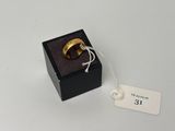 a close up of a ring in a black box with a price tag
