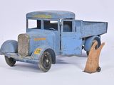 a toy truck that is sitting on a white surface