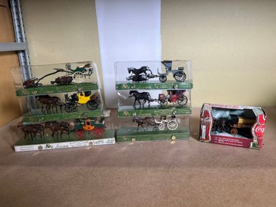 a lot of toy horses and carriages on the table
