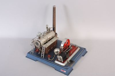 a small model of a steam engine on a blue platform