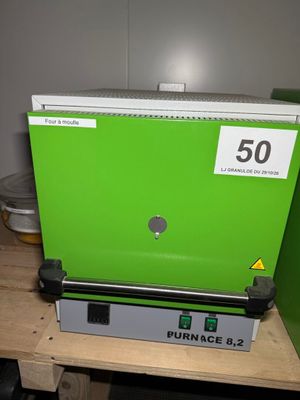 une image représentant une machine verte posée sur une table en bois