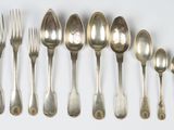 a lot of silver spoons and forks on the table
