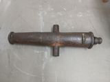 an old rusty pipe on the floor next to a chair