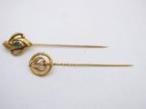 a pair of gold plated hair pins with green and white stones