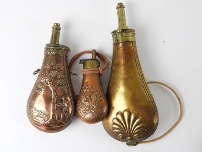 three different types of brass vases on a white surface